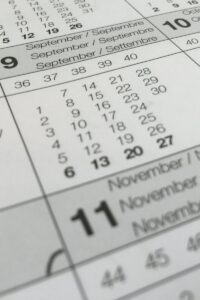 Detailed close-up of a calendar displaying months in several languages.